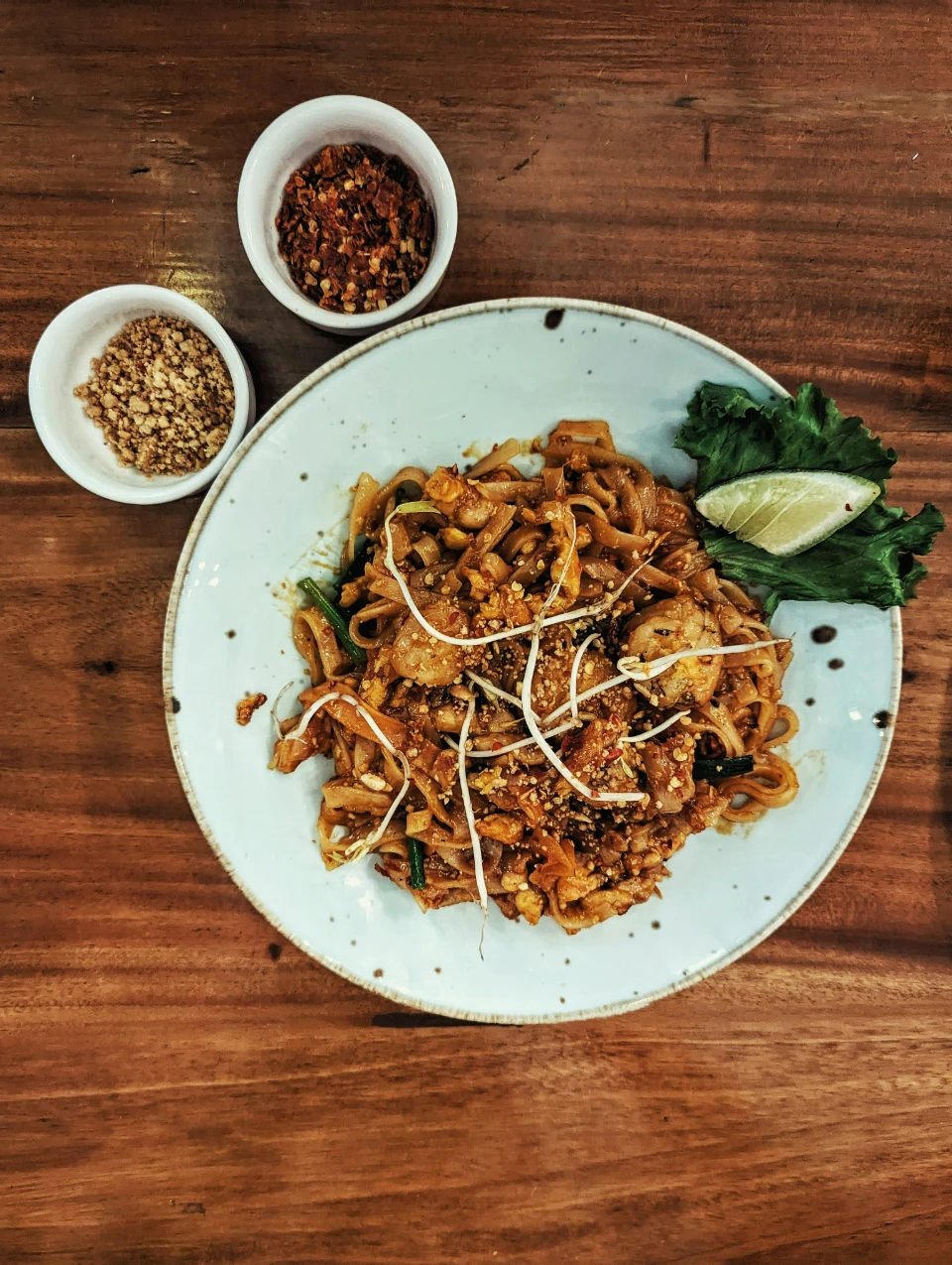 Stir-fried noodles and cucumber on a ceramic plate